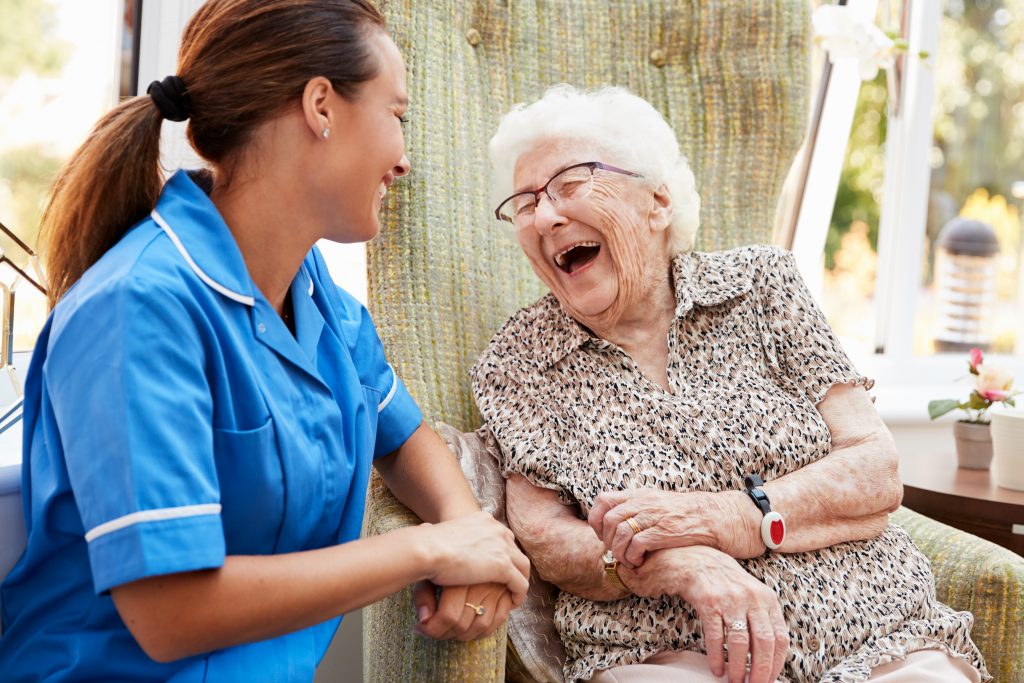 Healthcare worker with elderly woman at home.